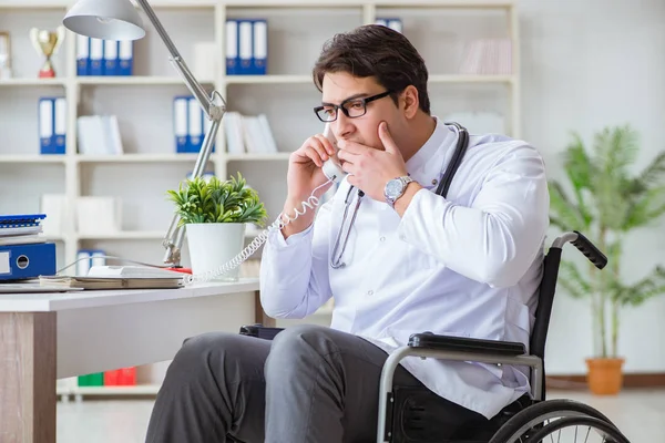 Disabled doctor on wheelchair working in hospital