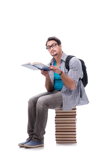 Giovane studente seduto sulla cima di libro pila su bianco — Foto Stock