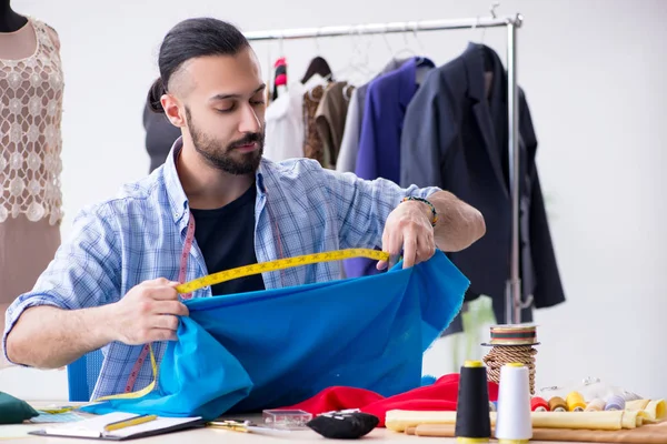 Male tailor working in the workshop on new designs — Stock Photo, Image