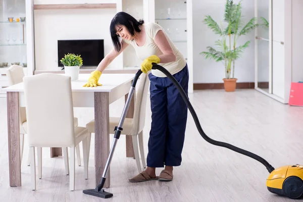 Senior old woman tired after vacuum cleaning house — Stock Photo, Image