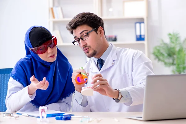 Dentist doctor and assistant working on new tooth implant