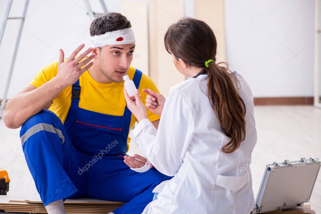 Worker with injured head and doctor