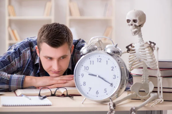 Student and skeleton preparing for school exams — Stock Photo, Image