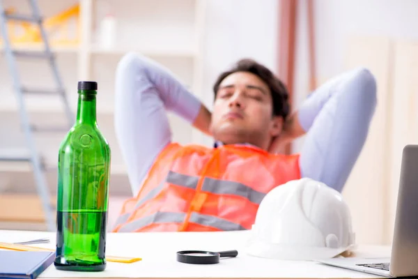 Drunk engineer working in the workshop — Stock Photo, Image