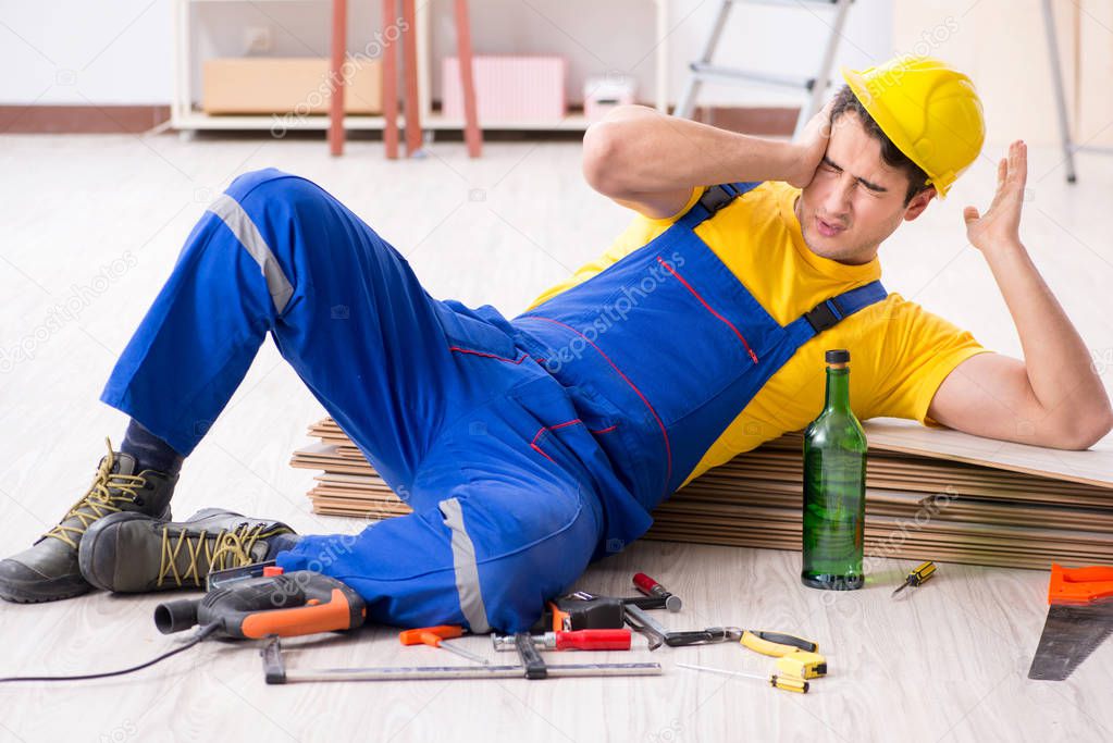 Floor repairman drinking alcohol during break