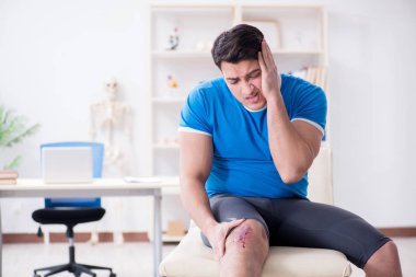 Spor sakatlığı geçiren hasta doktoru ziyaret ediyor.