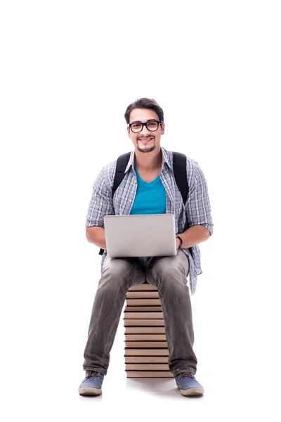 Jonge studente zit op de top van boek stapel op wit — Stockfoto