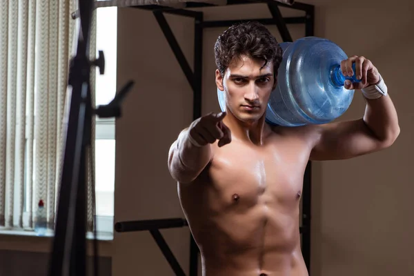 Muscular ripped man with big water bottle — Stock Photo, Image