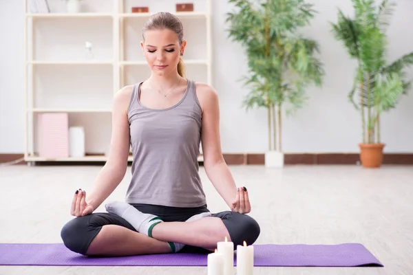 Mujer joven en pose de loto meditando en gimnasio spa —  Fotos de Stock