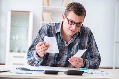 Young man frustrated at his house and tax bills clipart