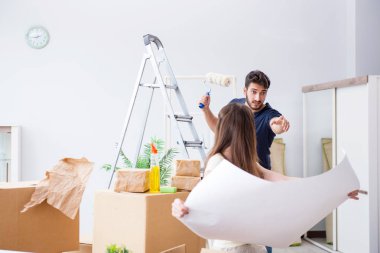 Yeni evdeki kutuları açan genç bir aile.