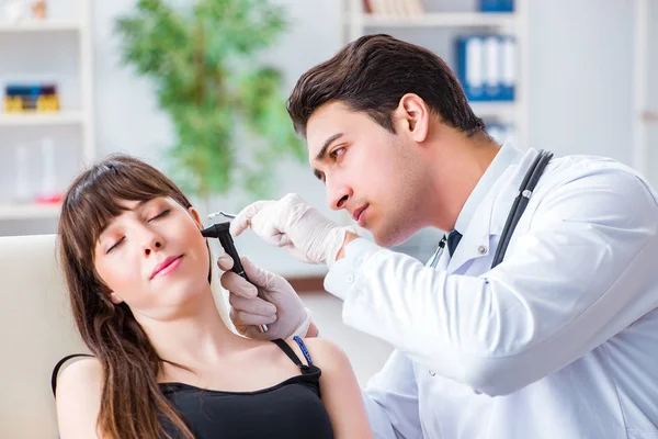 Doctor checking patients ear during medical examination