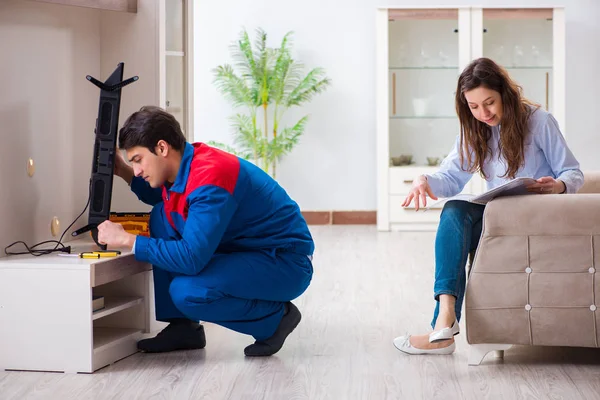 Repairman repairing tv at home