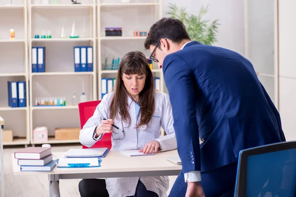 Businessman discussing health issues with doctor