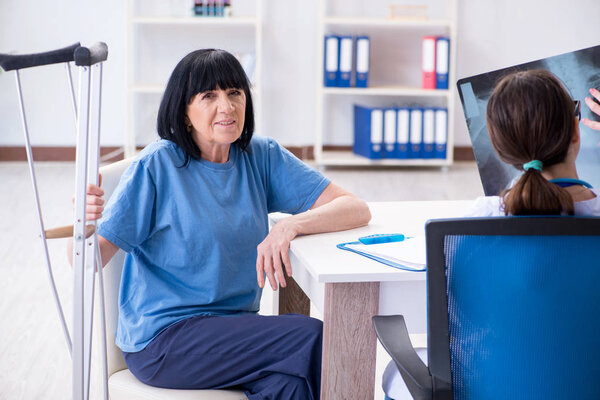 Doctor examining old mature woman after incident