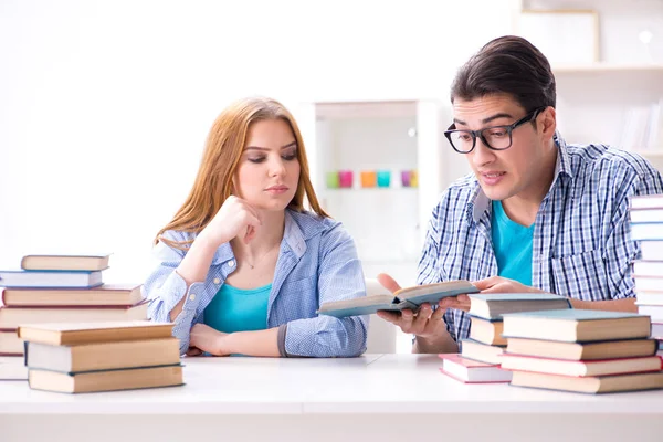 Pair of students studying for university exams Stock Picture