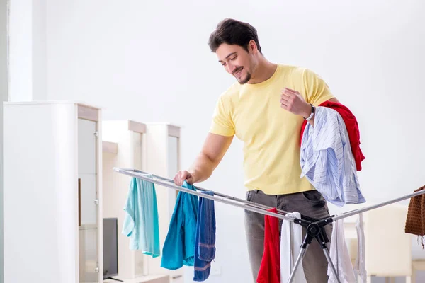 Handsome man husband doing laundering at home — Stock Photo, Image