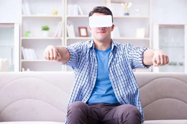 Man with virtual reality glasses playing at home — Stock Photo, Image