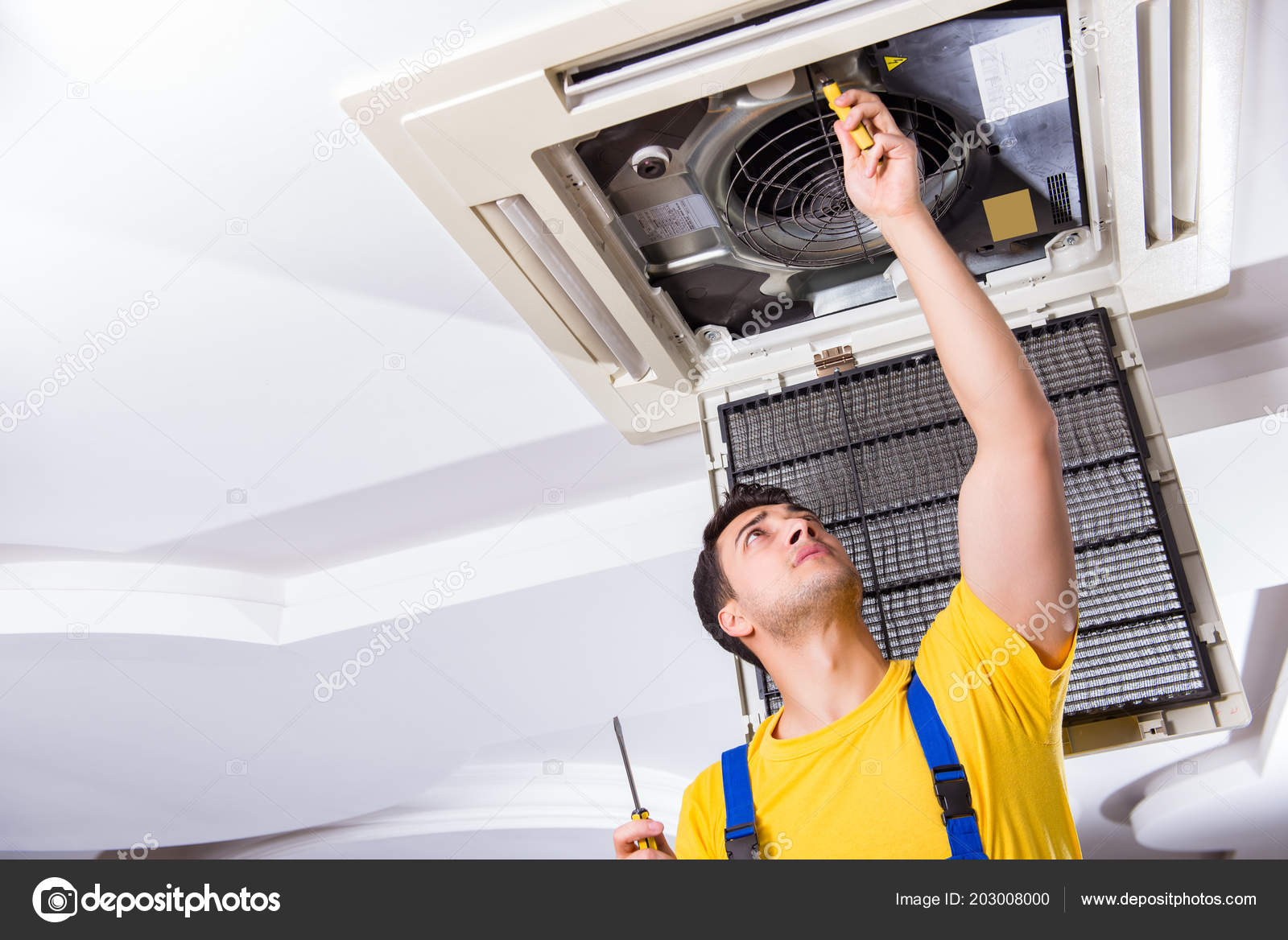 Repairman Repairing Ceiling Air Conditioning Unit Stock