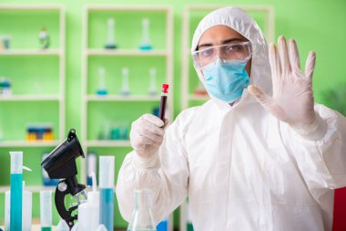 Laboratuvarda yeni bir deney üzerinde çalışan kimyager.