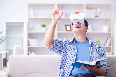 Evde sanal gerçeklik gözlükleriyle serbest çalışan bir öğrenci.