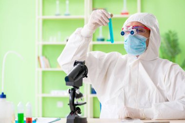 Laboratuvarda yeni bir deney üzerinde çalışan kimyager.