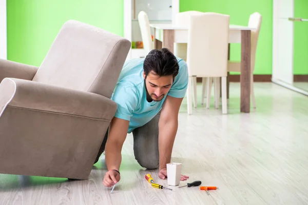 Man repairing furniture at home