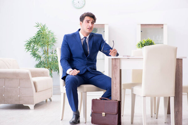 Bankrupt businessman angry and upset at home