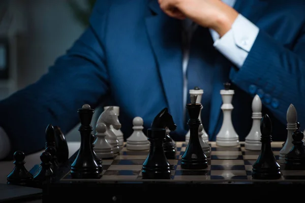 Businessman playing chess in strategy concept — Stock Photo, Image