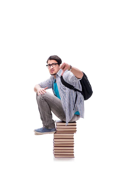 Joven estudiante sentado en la parte superior de la pila de libros en blanco — Foto de Stock