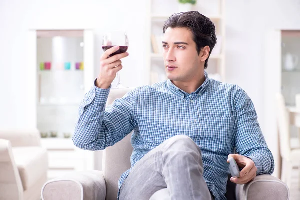 Young man drinking wine at home — Stock Photo, Image