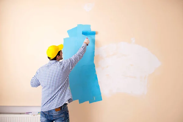 Pintor hombre pintando la pared en casa —  Fotos de Stock