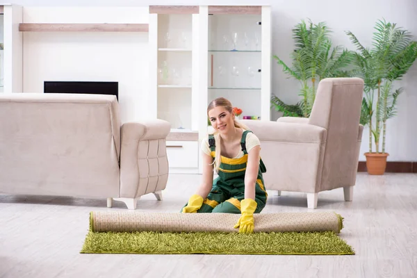 Professional female cleaner cleaning carpet