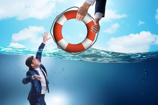 Businessman being saved from drowning — Stock Photo, Image