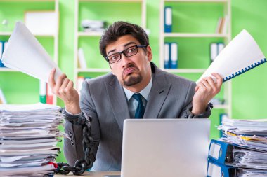 Çalışan, iş yükü nedeniyle masasına zincirlenmiş.