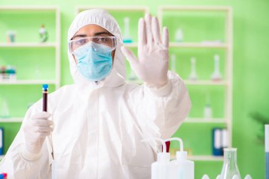 Laboratuvarda yeni bir deney üzerinde çalışan kimyager.