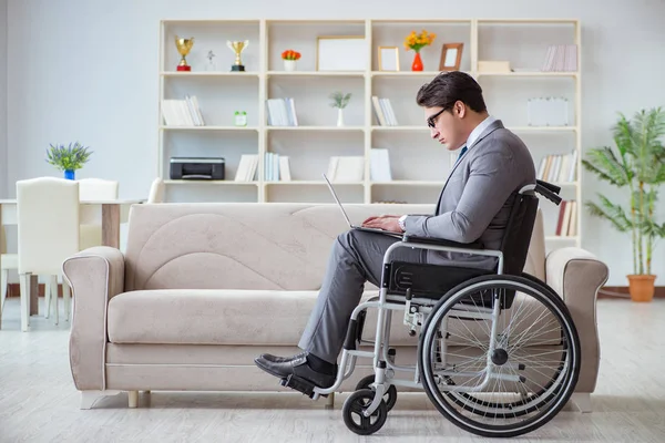 stock image Dsabled businessman on wheelchair working home