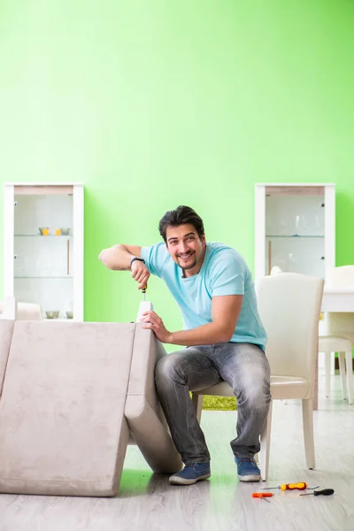 Man repairing furniture at home