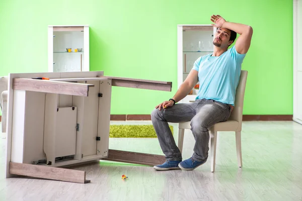 Man repairing furniture at home