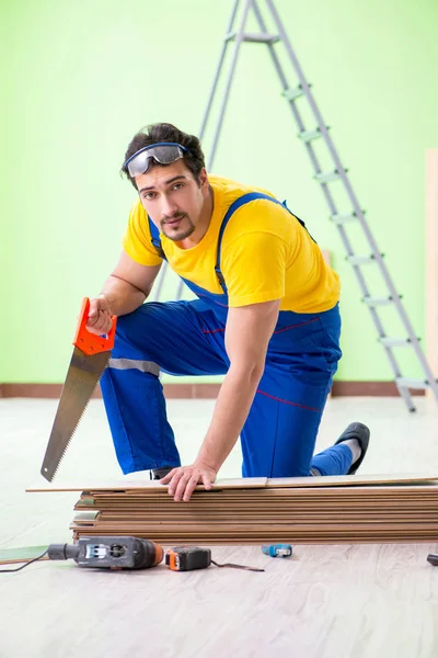 Professional contractor laying flooring at home