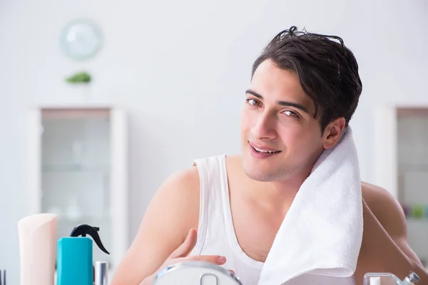 Young handsome man staring in the mirror — Stock Photo, Image