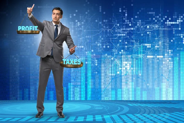 Businessman comparing profit and taxes — Stock Photo, Image