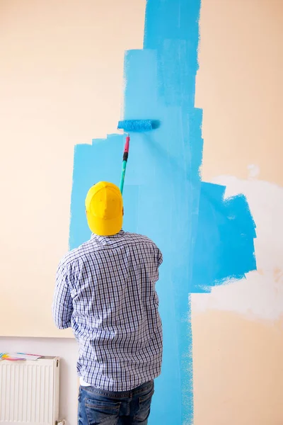 Pintor hombre pintando la pared en casa — Foto de Stock