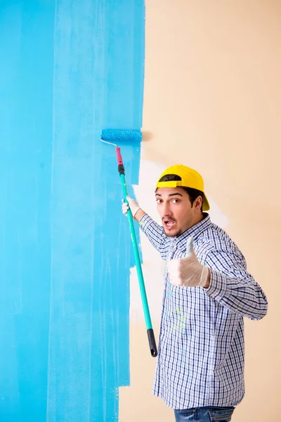 Pintor hombre pintando la pared en casa — Foto de Stock