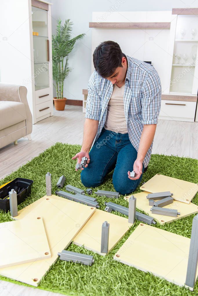 Man assembling furniture at home