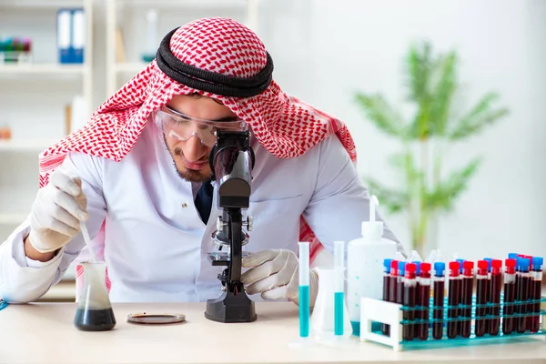 Arab chemist scientist testing quality of oil petrol — Stock Photo, Image