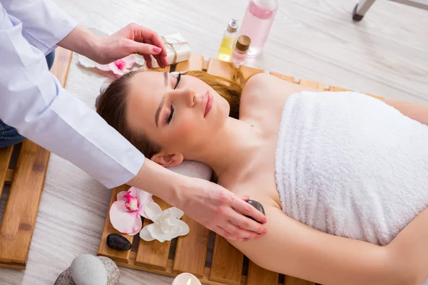 Young woman during spa procedure in salon