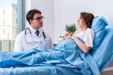 Hastane odasında hamile bir doktor var.