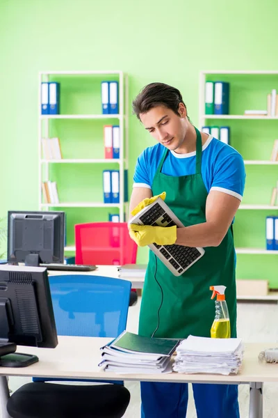 Male handsome professional cleaner working in the office