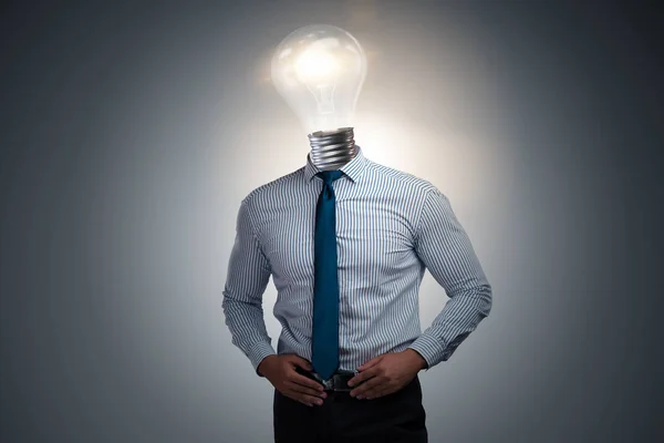 Businessman in bright idea concept with lightbulb head — Stock Photo, Image